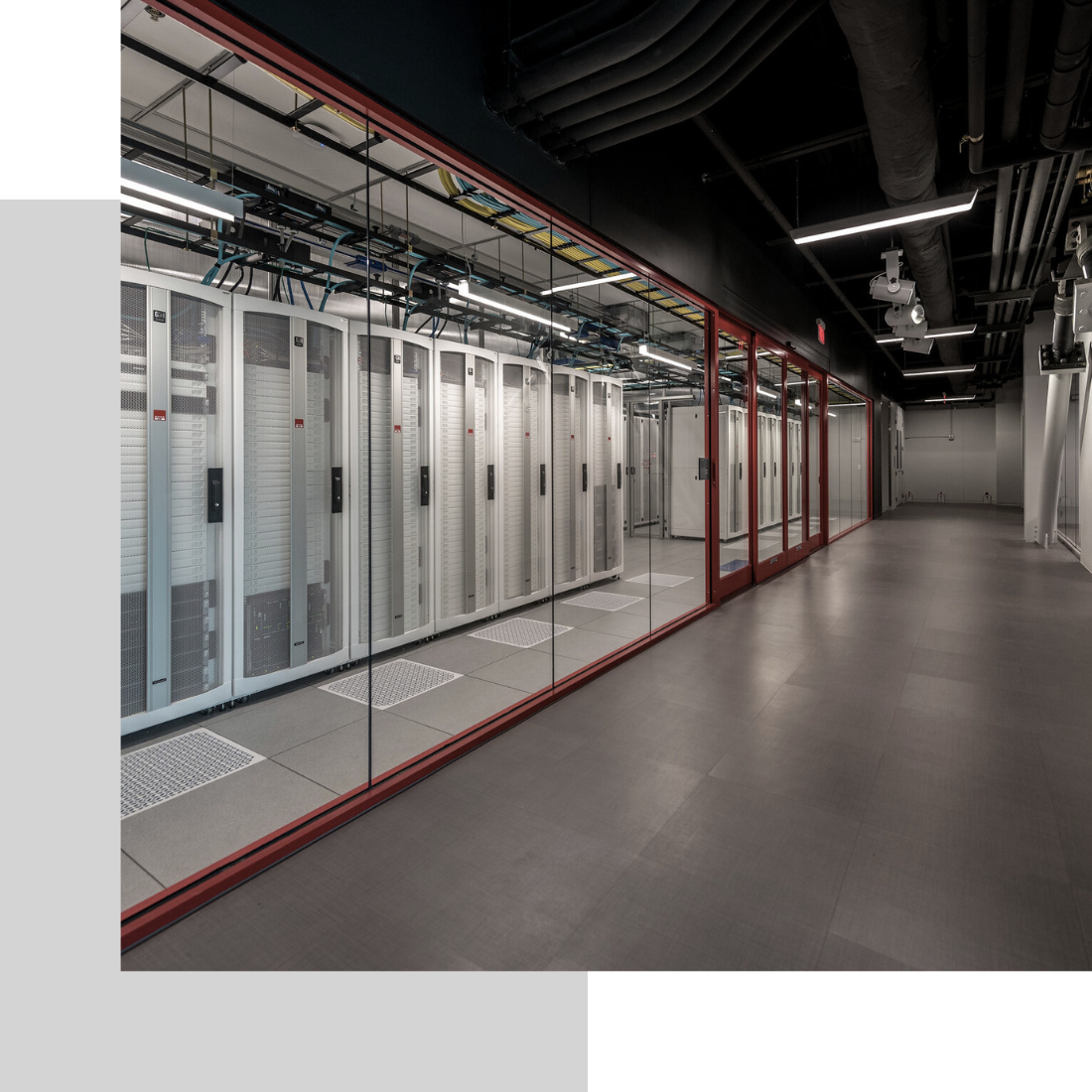 data center server room behind glass wall down hall in perspective