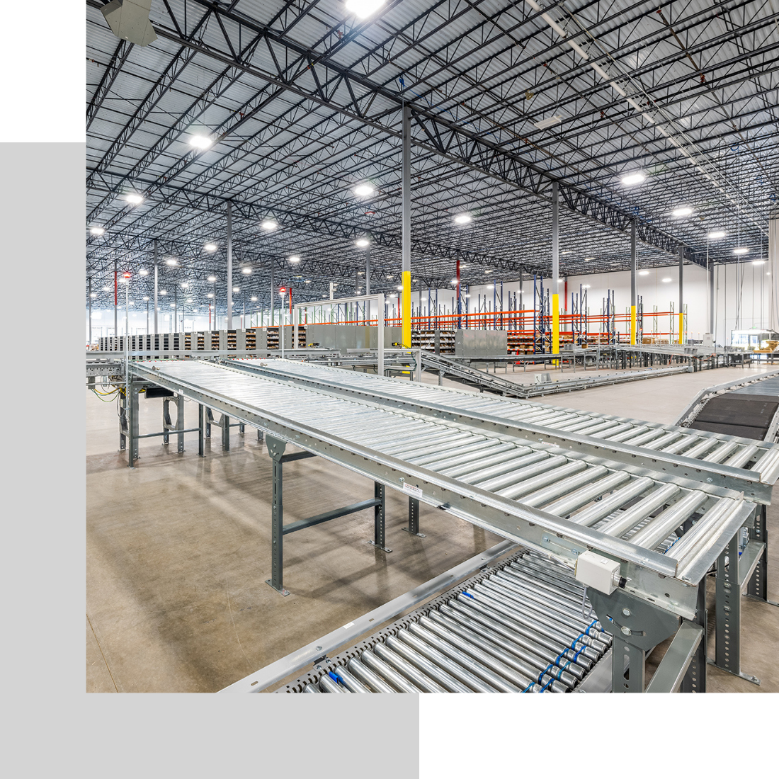warehouse with conveyer belt lit up by overhead lighting